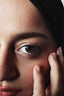 Close-up of smooth under-eye skin and fresh makeup at the end of winter